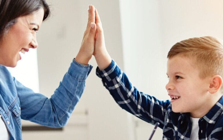 mother and son high fiving