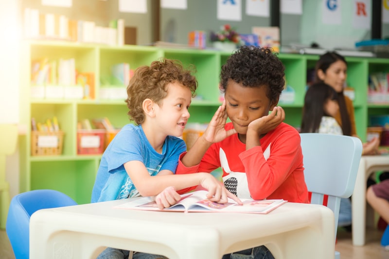 two young boys reading together