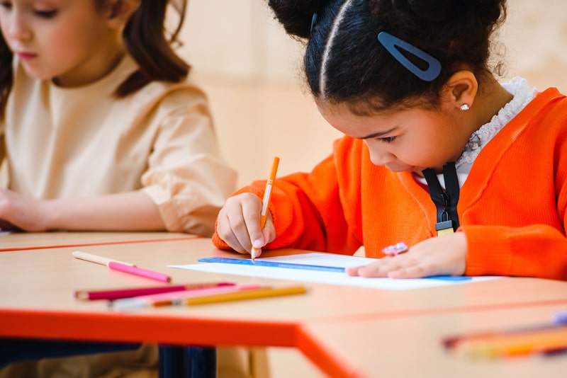 young girls drawing in a classroom