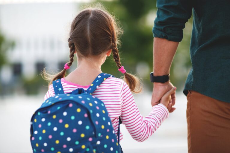 father walking daughter to school