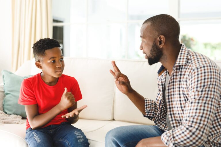 father and son playing rock paper scissors