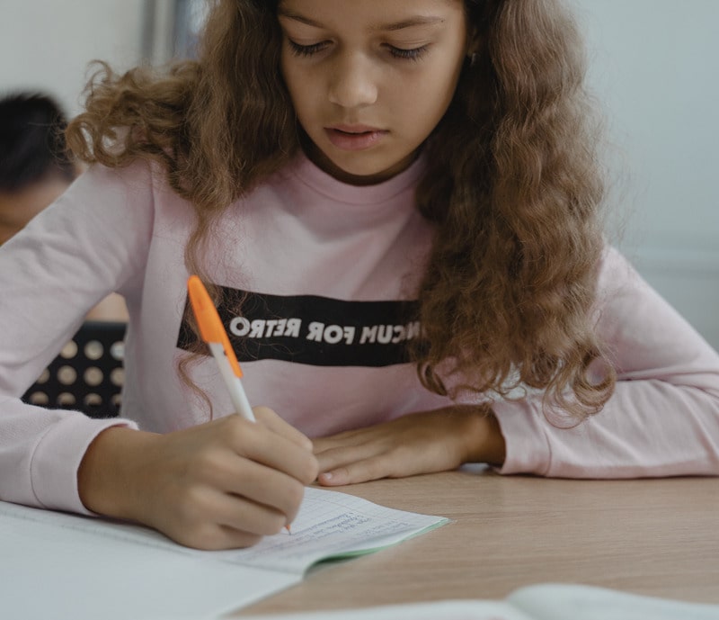 girl writing with a pen