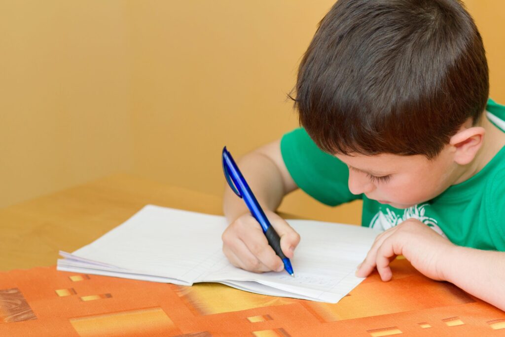 boy writing on paper