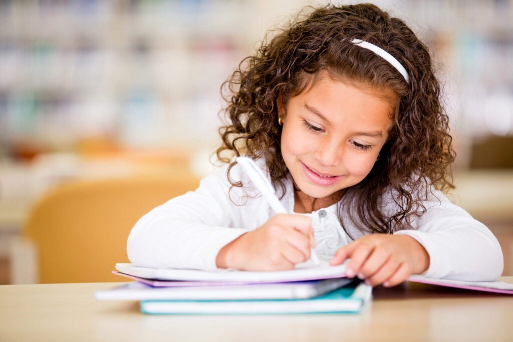 girl writing on notebook