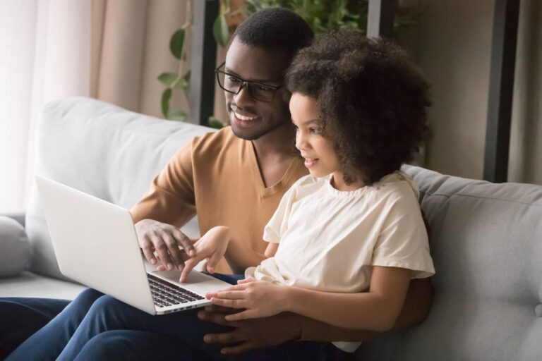 father and daughter on laptop