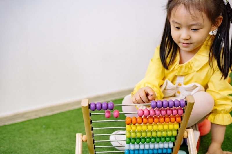 girl playing with abacus