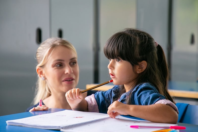 teaching helping young girl with classword