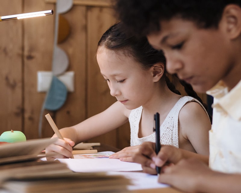 two kids working at school