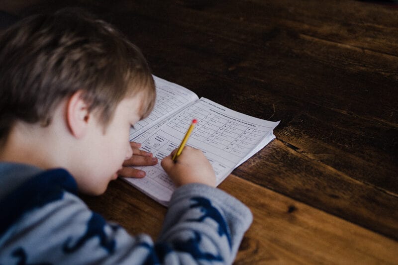 young boy doing his math homework