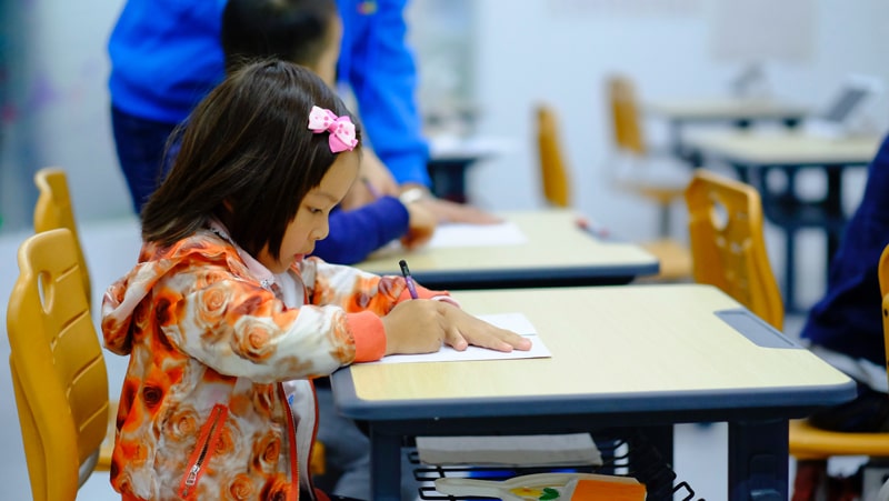 young girl drawing in a classroom