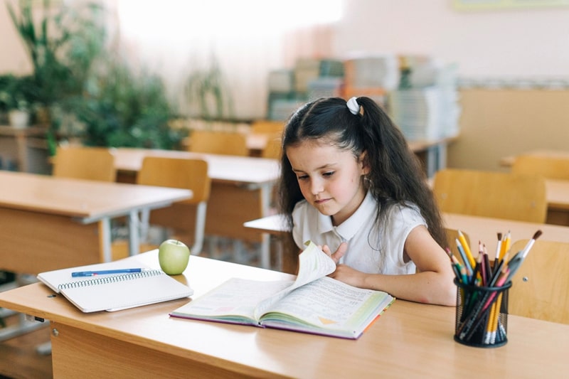 young girl studying in a classroom